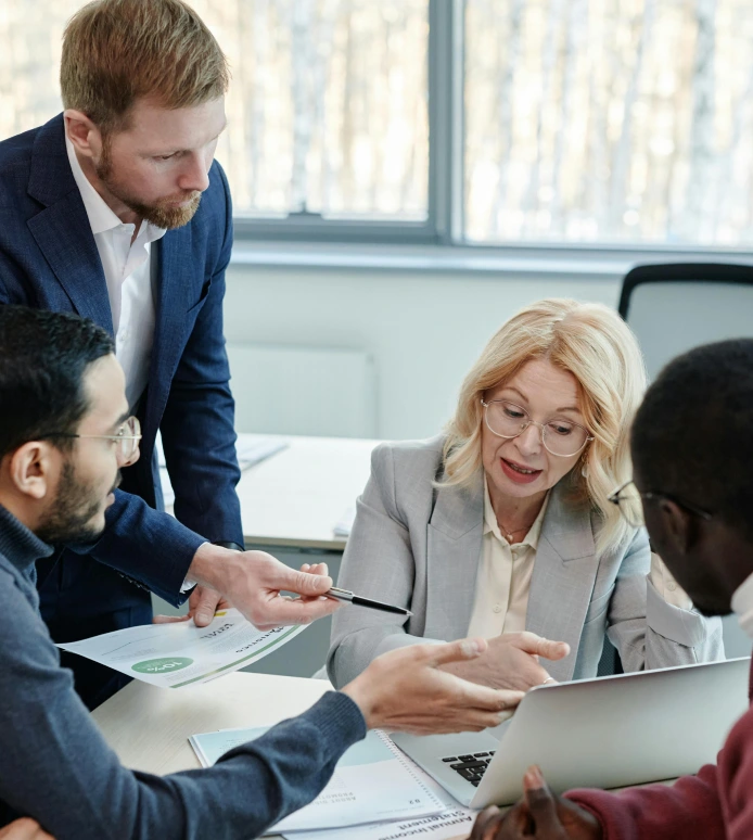 Business professionals in meeting discussing institutional services