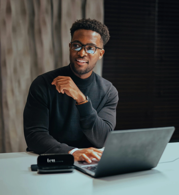 Professional working on laptop in modern office environment